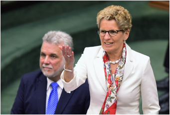 Description : ntario Premier Kathleen Wynne thanks Quebec Premier Philippe Couillard for his speech at Queen's Park in Toronto on May 11. They'll meet again on Friday - along with their cabinets.